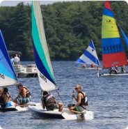 Youth sailors racing small dinghies on the water