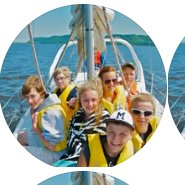 Youth sailors in life jackets aboard a Connections Youth Sailing boat